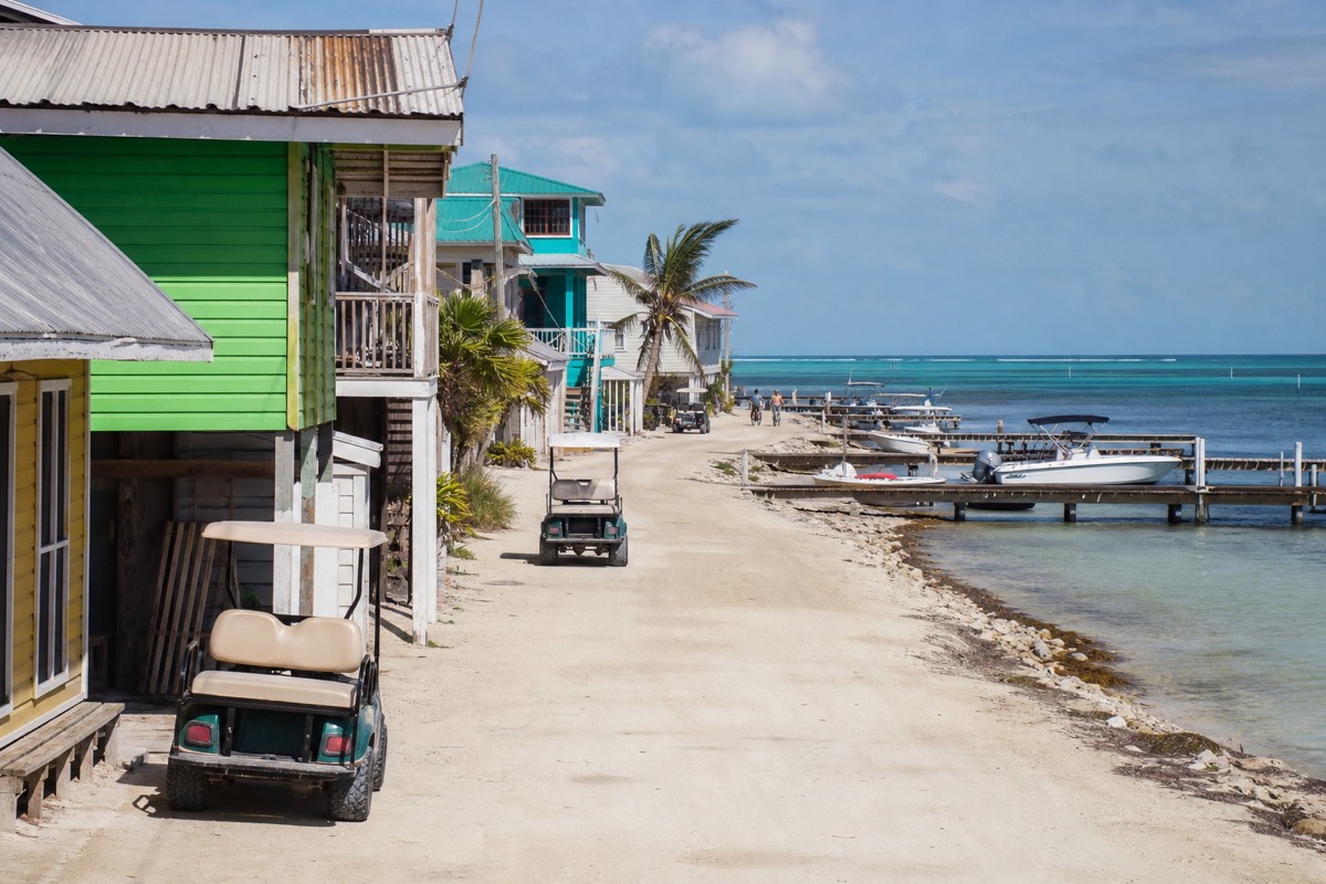 Snorkeling boats moored off the San Pedro waterfront on Ambergris Caye with the reef line breaking offshore